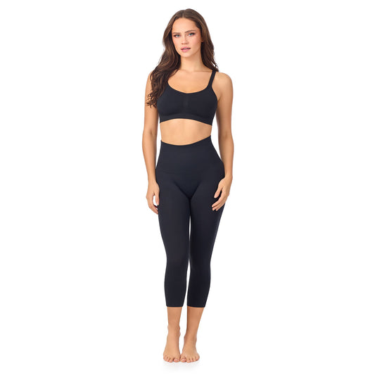 A lady wearing Seamless Comfort Smoothing 3/4 Legging in Black