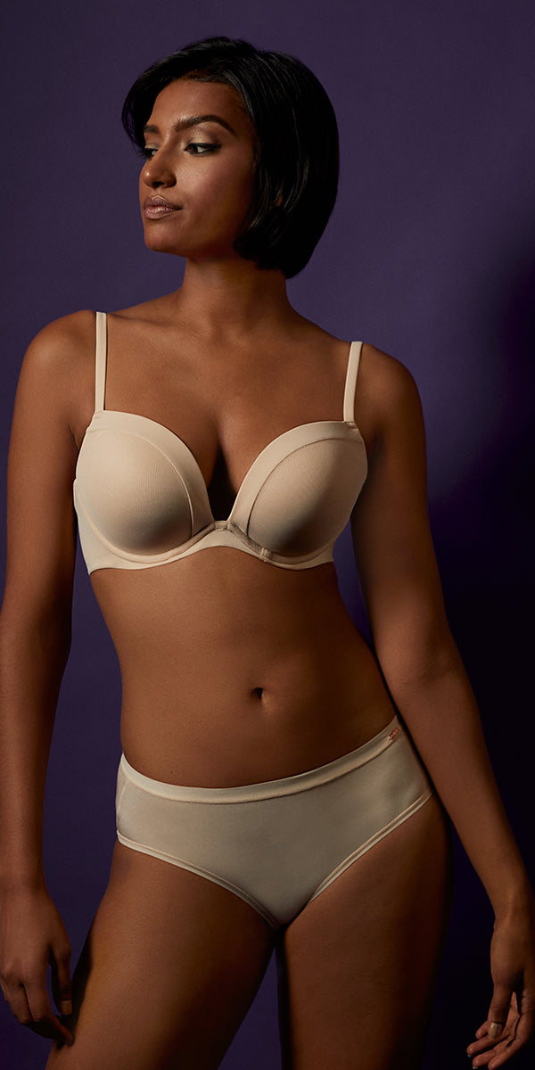 A lady wearing a almond infinite possibilities plunge bra.