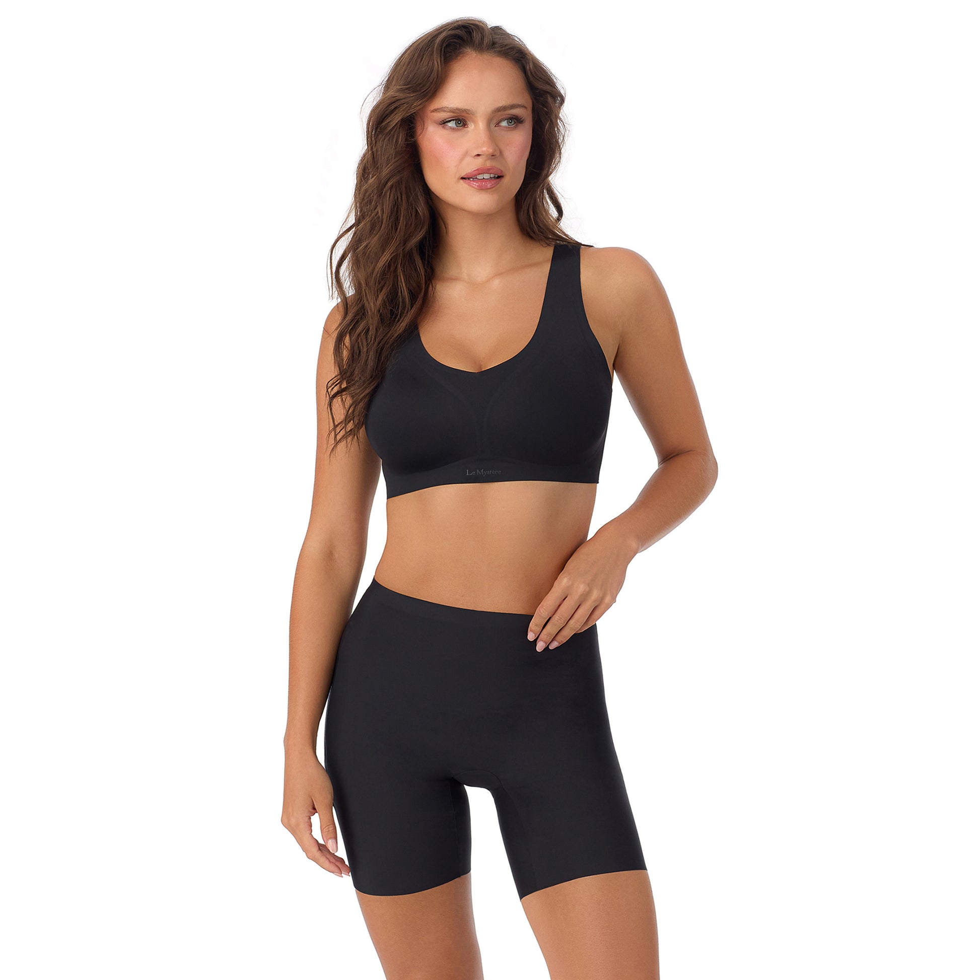 A Lady Wearing Cooling Comfort Active Wireless - Black facing front with a standing pose while looking to the side