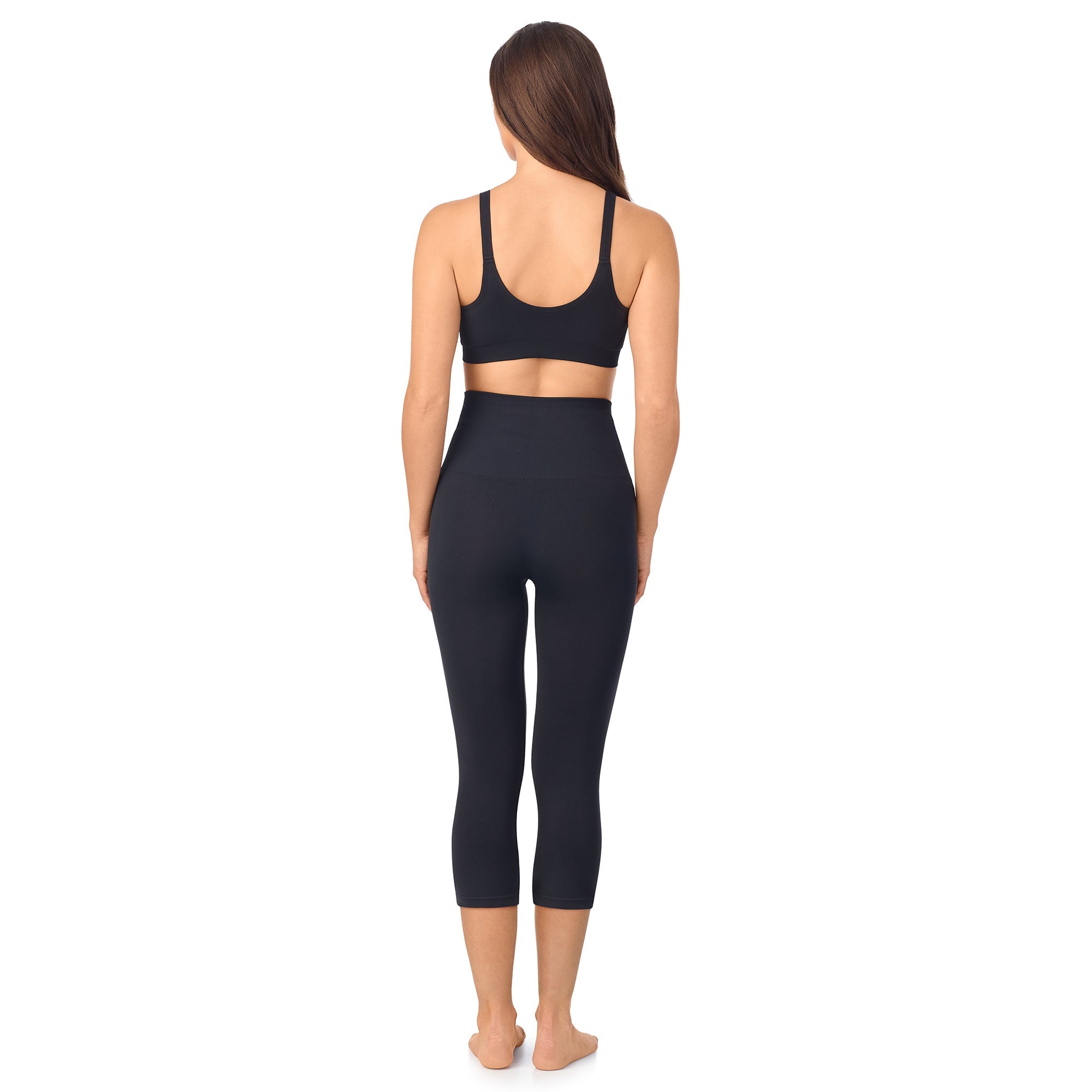 A lady wearing Seamless Comfort Smoothing 3/4 Legging in Black