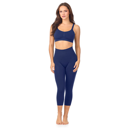 A lady wearing Seamless Comfort Smoothing 3/4 Legging in True Navy