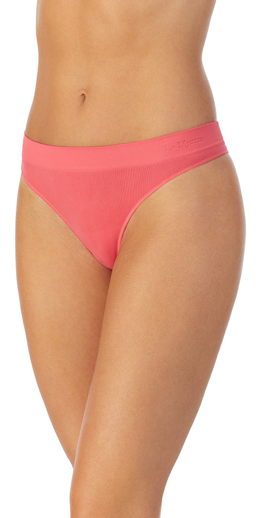 A lady wearing a sweet coral Seamless Comfort Thong