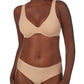 A lady wearing a natural smooth shape unlined underwire bra.